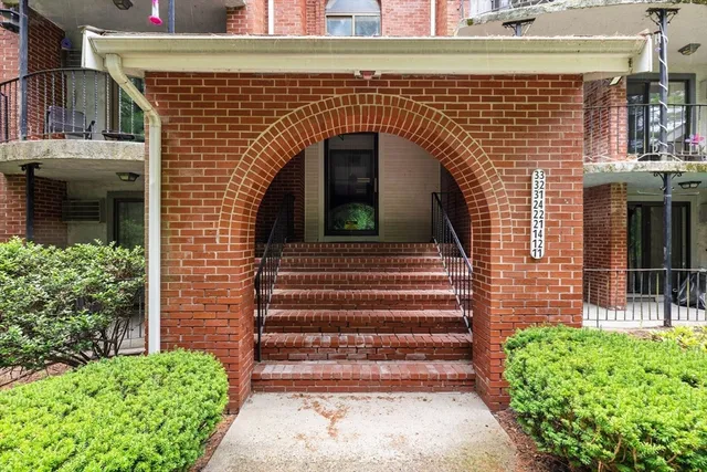 a front view of a house with plants