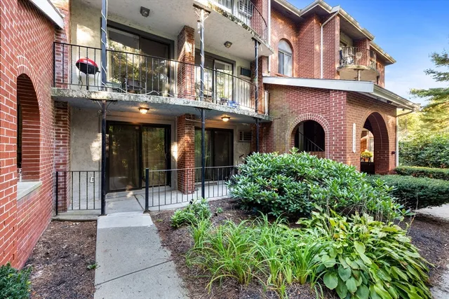 a front view of a building with garden