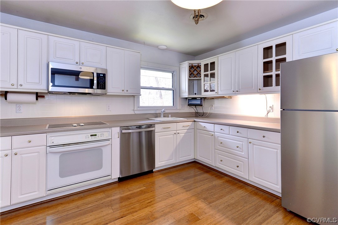 130 Cooley Road Williamsburg, VA 23188 - Photo 11 of 30 a kitchen with granite countertop white cabinets and white appliances