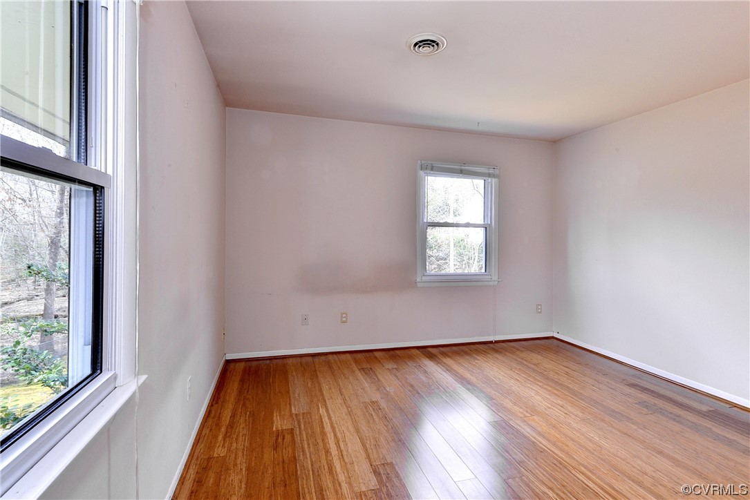 130 Cooley Road Williamsburg, VA 23188 - Photo 13 of 30 an empty room with wooden floor and windows