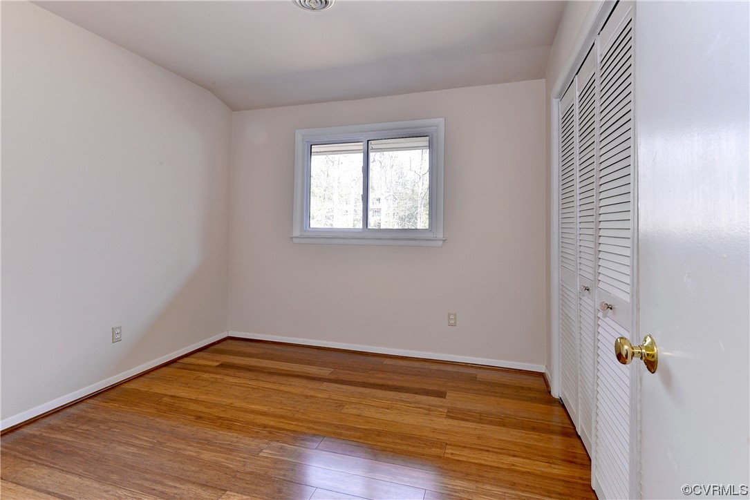 130 Cooley Road Williamsburg, VA 23188 - Photo 17 of 30 an empty room with wooden floor and windows