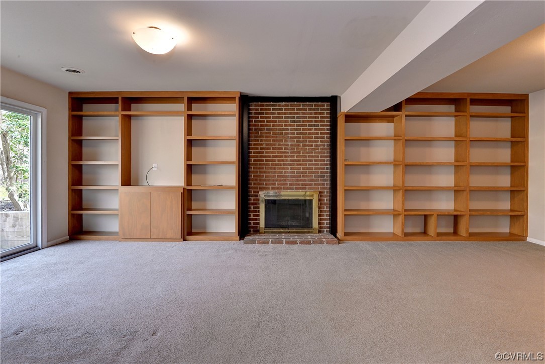 130 Cooley Road Williamsburg, VA 23188 - Photo 18 of 30 an empty room with a fireplace and cabinet