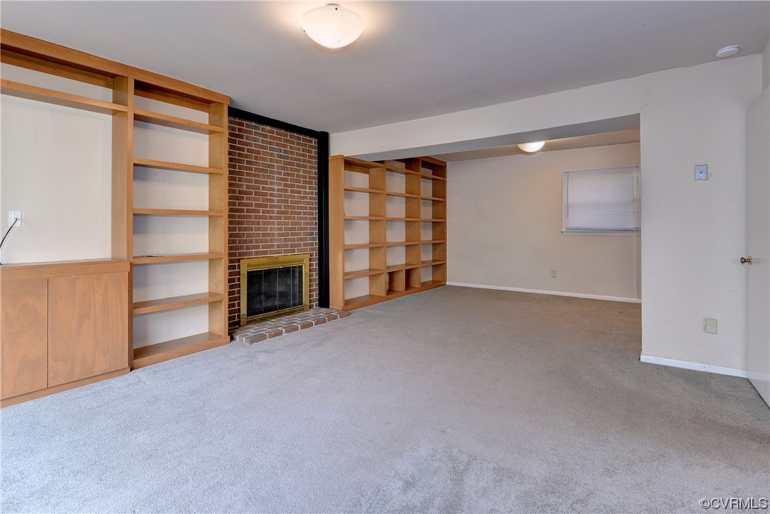 130 Cooley Road Williamsburg, VA 23188 - Photo 19 of 30 a view of an empty room with a fireplace and a window