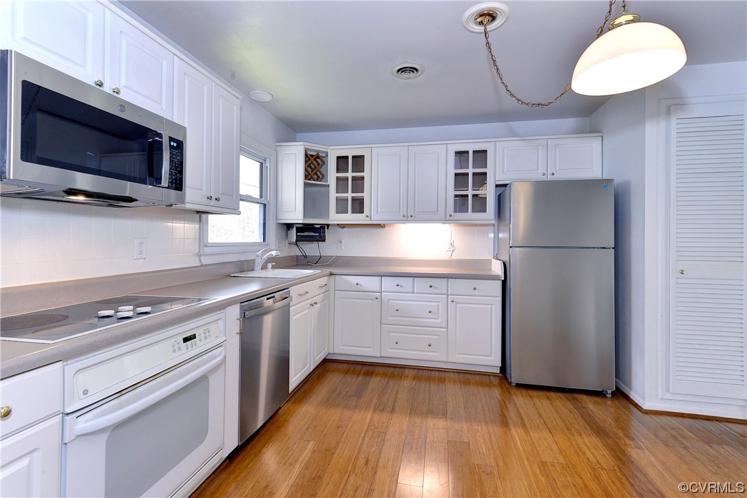 130 Cooley Road Williamsburg, VA 23188 - Photo 8 of 30 a kitchen with a refrigerator and a stove top oven