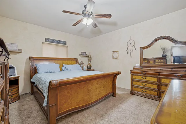 a bedroom with bed and a chandelier