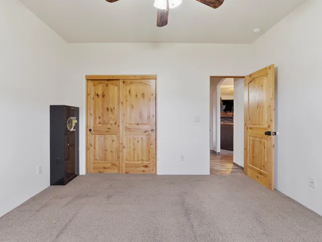 an empty room with window and bathroom