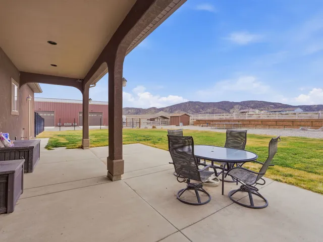 a view of a patio with a table and chairs