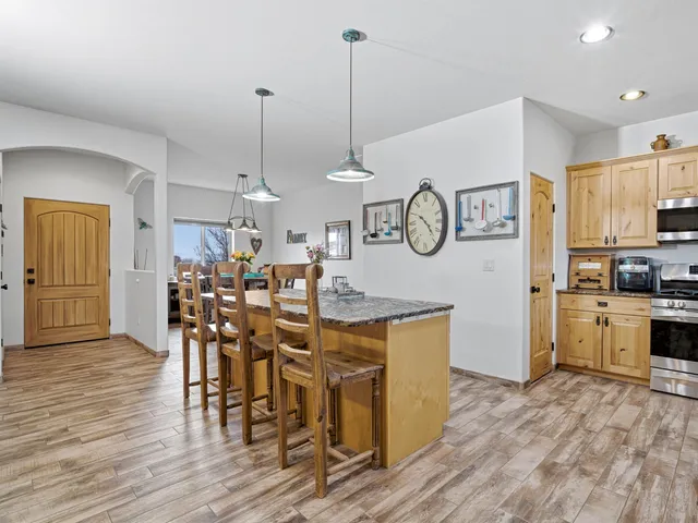 a view of a dining room and kitchen with furniture wooden floor and window