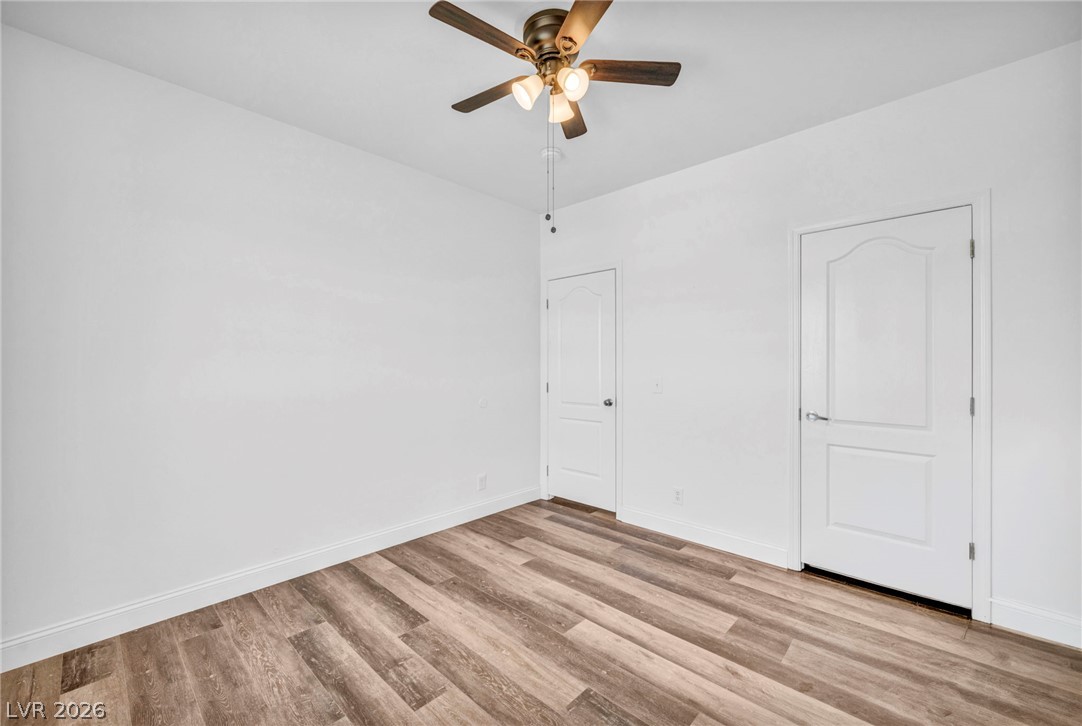 225 California Street Searchlight, NV 89046 - Photo 37 of 64 A quiet bedroom featuring resilient wood-look flooring and a functional ceiling fan.
