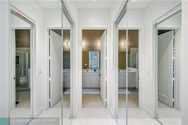 a bathroom with a double vanity sink a toilet and shower