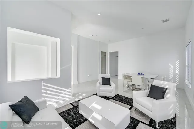 a living room with couches and a table with wooden floor