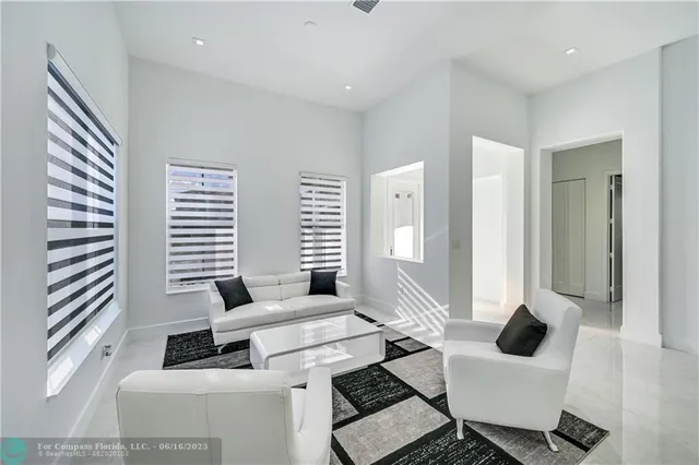 a living room with furniture and large windows