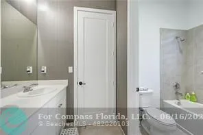 a spacious bathroom with a granite countertop sink a toilet and shower