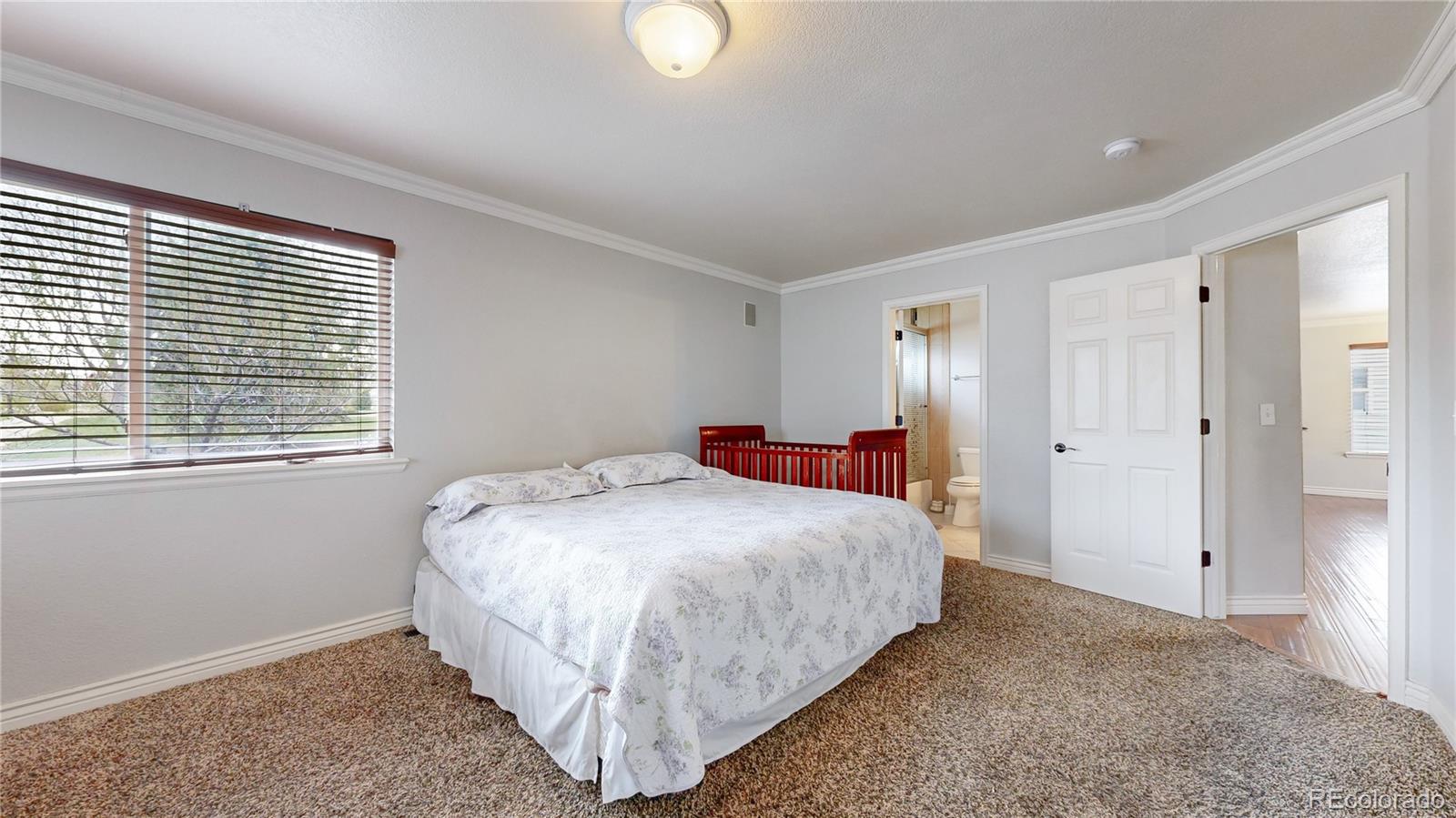 1173 Fall River Circle Longmont, CO 80504 - Photo 12 of 47 a bedroom with a bed and a window