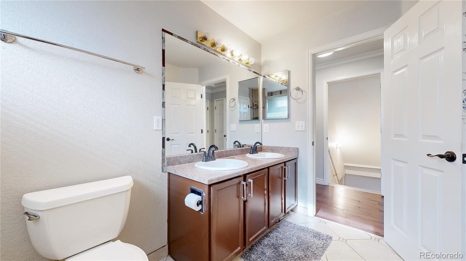 1173 Fall River Circle Longmont, CO 80504 - Photo 14 of 47 a bathroom with a toilet sink and mirror