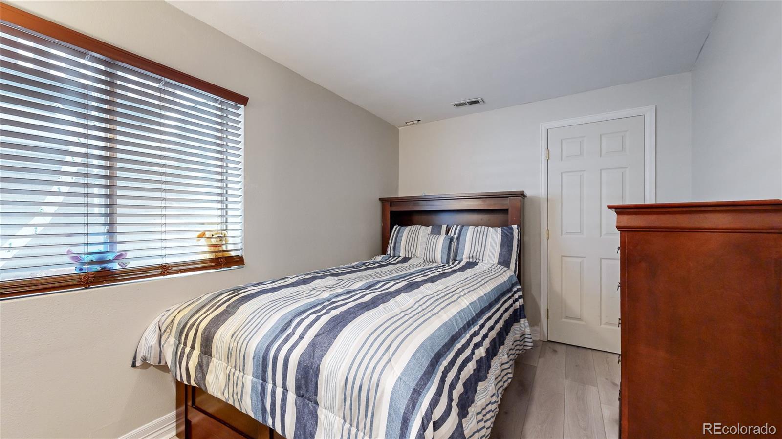 1173 Fall River Circle Longmont, CO 80504 - Photo 16 of 47 a bedroom with a bed and a window