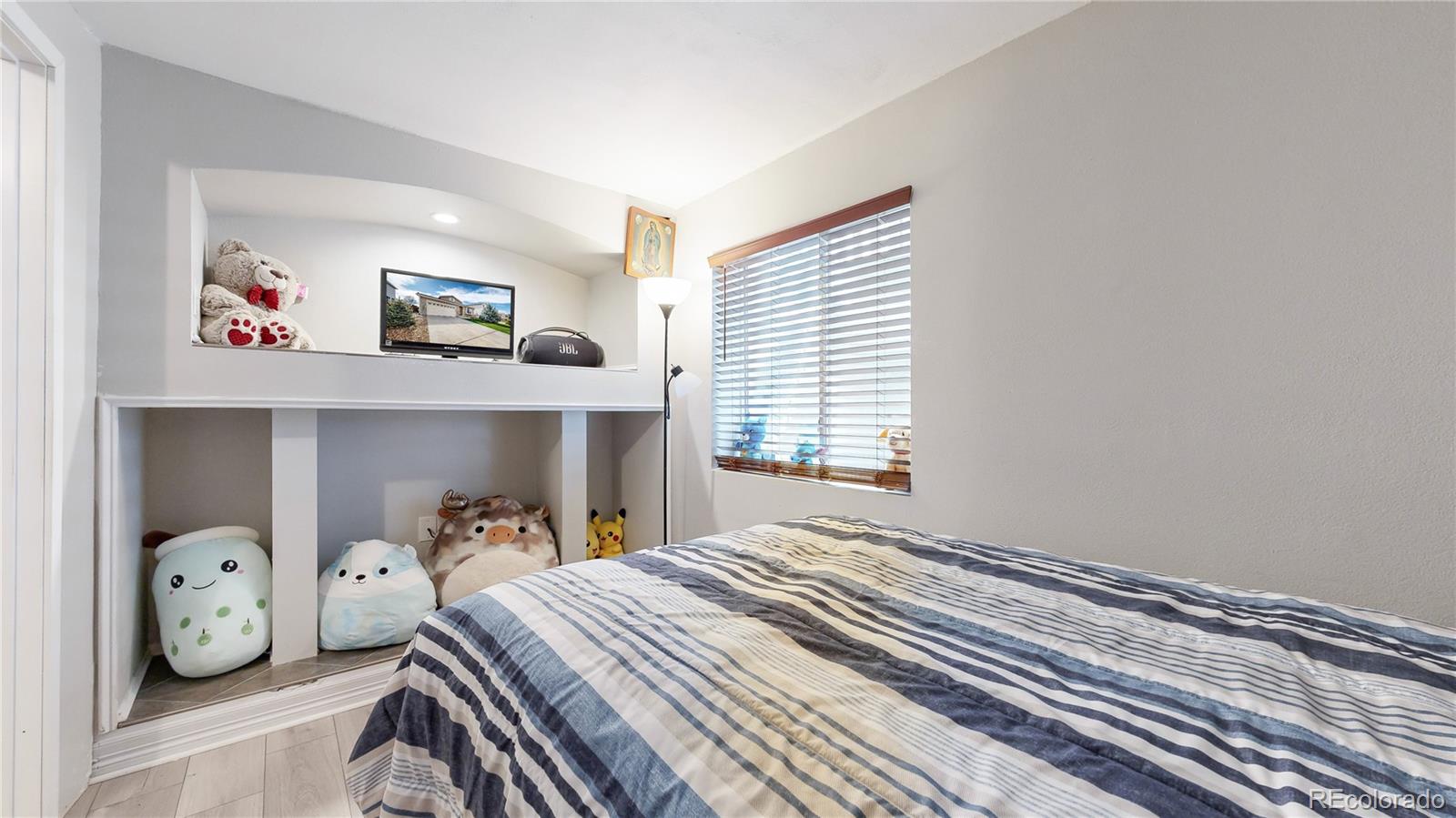 1173 Fall River Circle Longmont, CO 80504 - Photo 17 of 47 a bedroom with a bed a window and wall painting