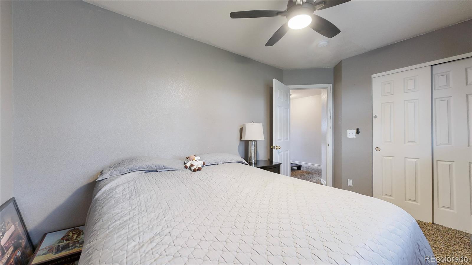 1173 Fall River Circle Longmont, CO 80504 - Photo 25 of 47 a bedroom with a bed and a chandelier