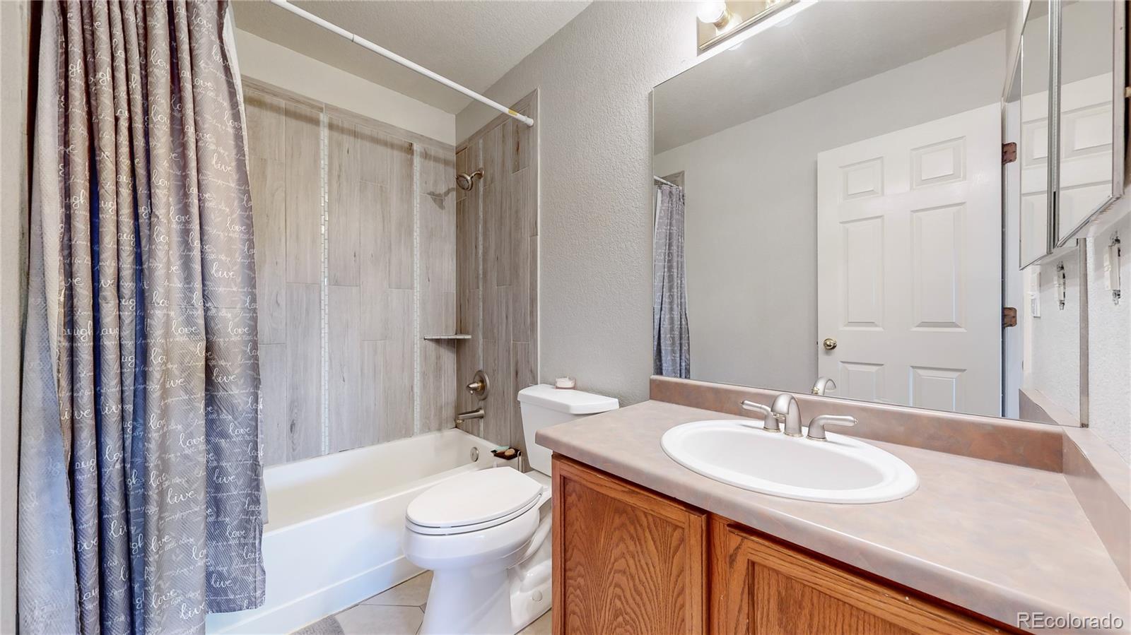 1173 Fall River Circle Longmont, CO 80504 - Photo 26 of 47 a bathroom with a sink toilet and shower