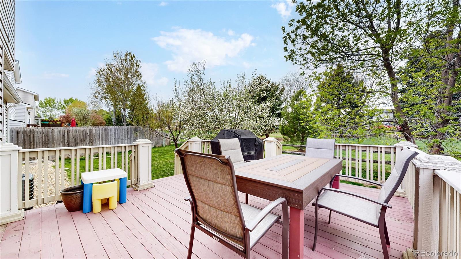 1173 Fall River Circle Longmont, CO 80504 - Photo 30 of 47 a view of a deck with furniture and trees