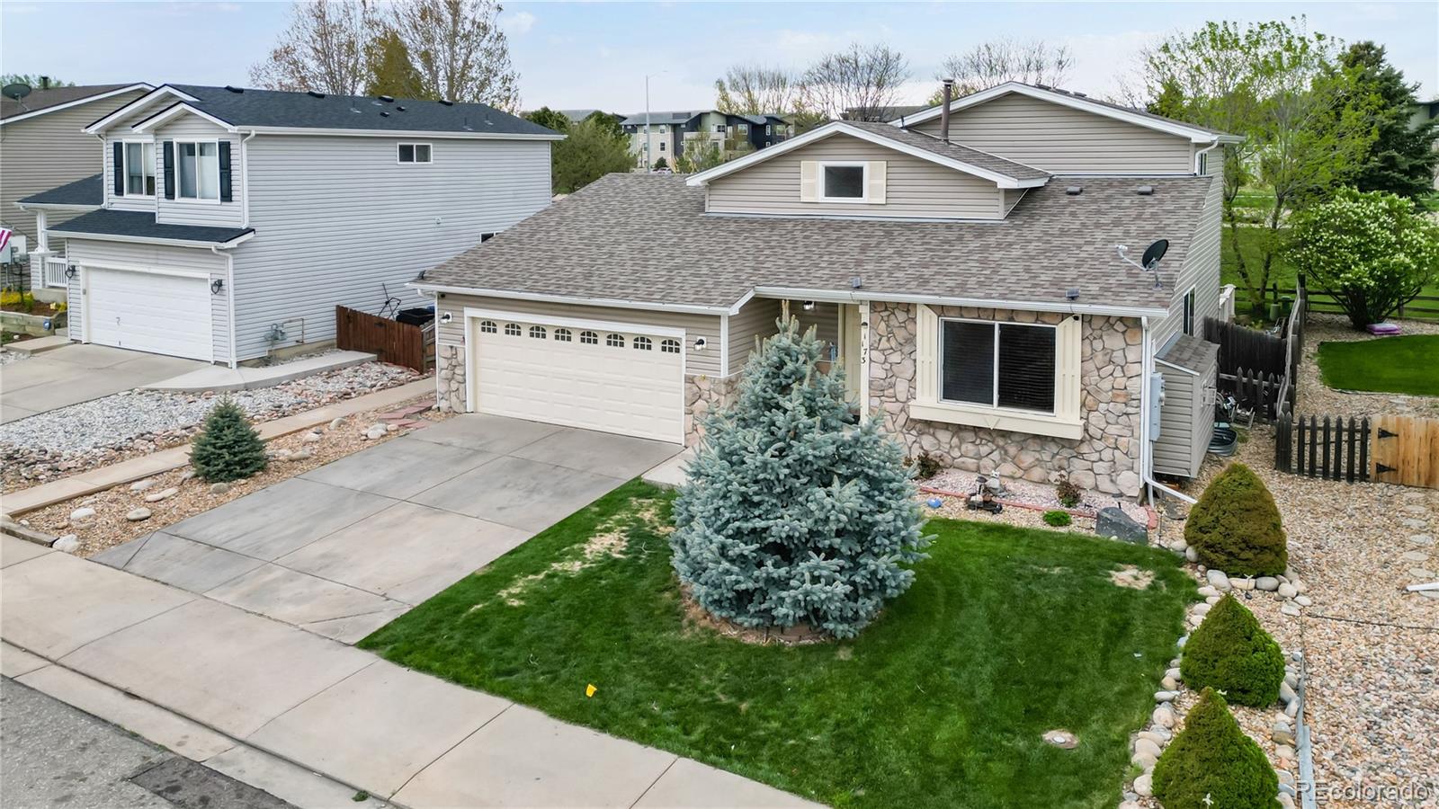 1173 Fall River Circle Longmont, CO 80504 - Photo 40 of 47 a front view of a house with a yard