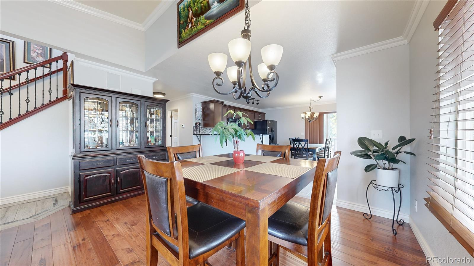 1173 Fall River Circle Longmont, CO 80504 - Photo 5 of 47 a view of a dining room with furniture a livingroom and chandelier