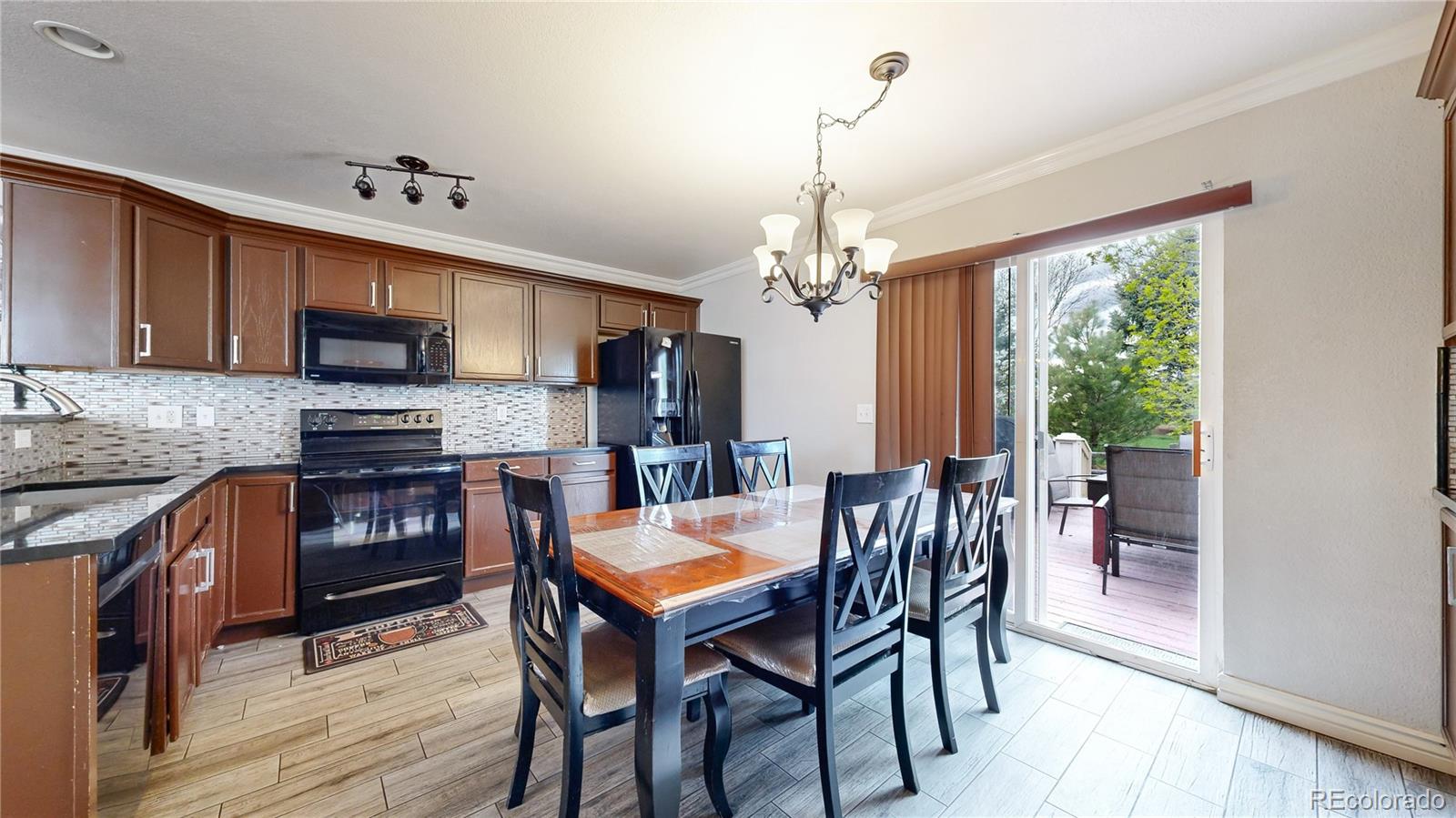 1173 Fall River Circle Longmont, CO 80504 - Photo 8 of 47 a view of a dining room with furniture window and wooden floor