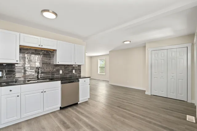 a kitchen with granite countertop a sink and cabinets