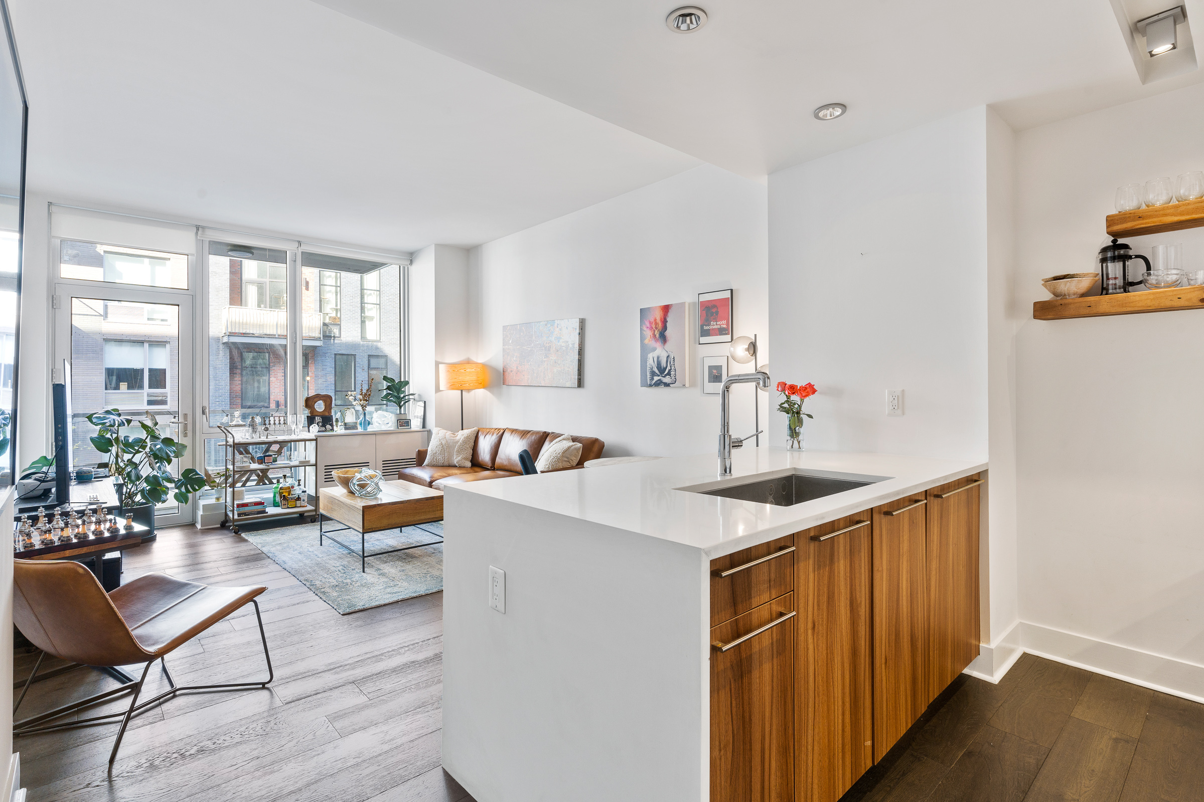 212 North 9th Street, Unit 3A Brooklyn, NY 11211 - Photo 1 of 8 a kitchen with a sink a stove a dining table and chairs