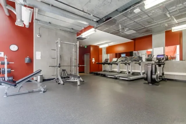 a kitchen with granite countertop a refrigerator stove and sink