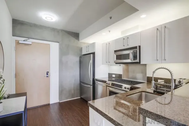 a bedroom with a large bed and dresser