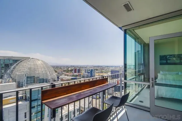 a living room with furniture tv and a floor to ceiling window