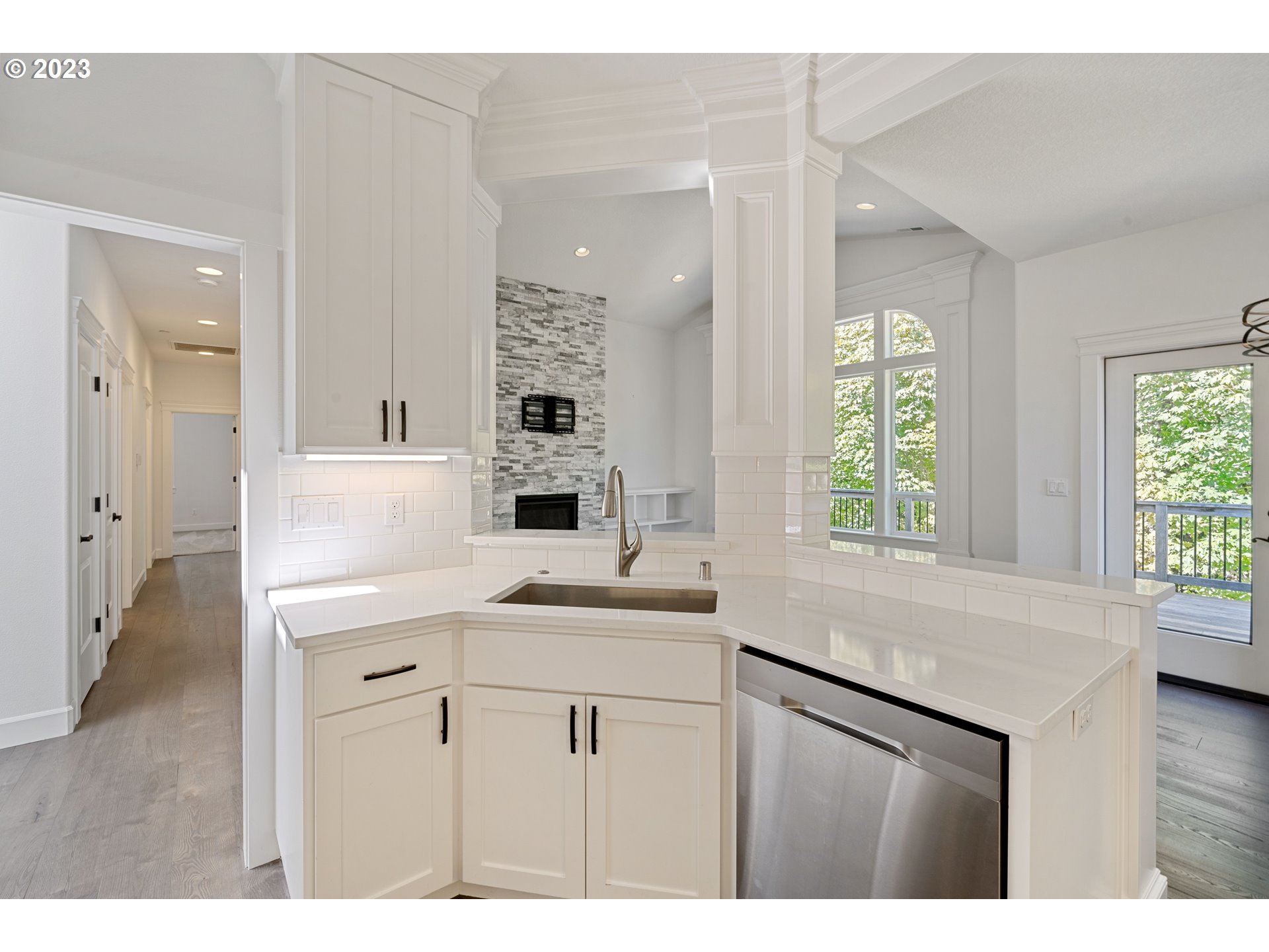2514 South 19th Court Ridgefield, WA 98642 - Photo 13 of 34 a kitchen with kitchen island white cabinets and sink