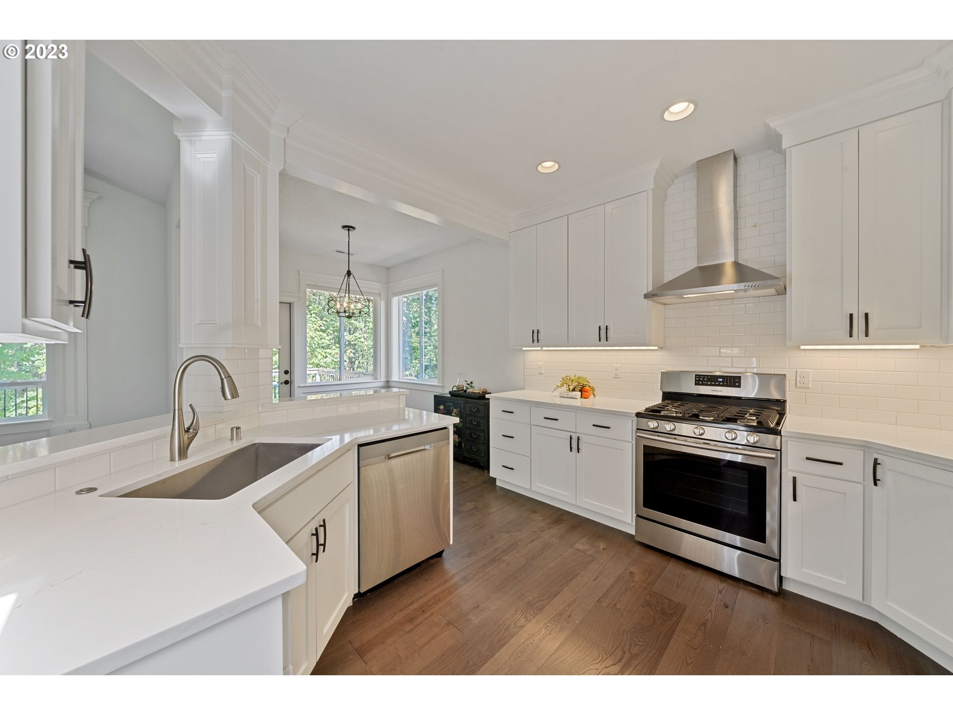 2514 South 19th Court Ridgefield, WA 98642 - Photo 14 of 34 a kitchen with white cabinets stainless steel appliances and sink