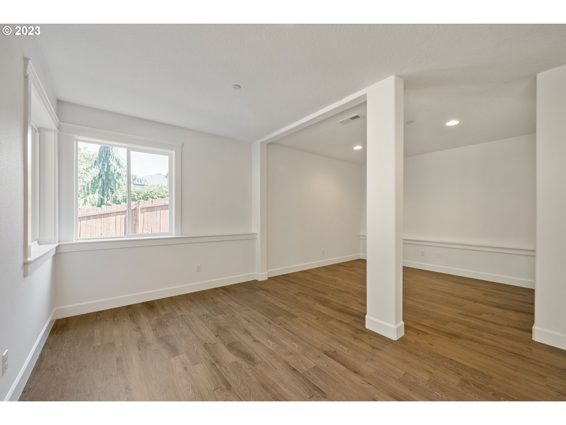 2514 South 19th Court Ridgefield, WA 98642 - Photo 24 of 34 a view of an empty room with wooden floor and a window