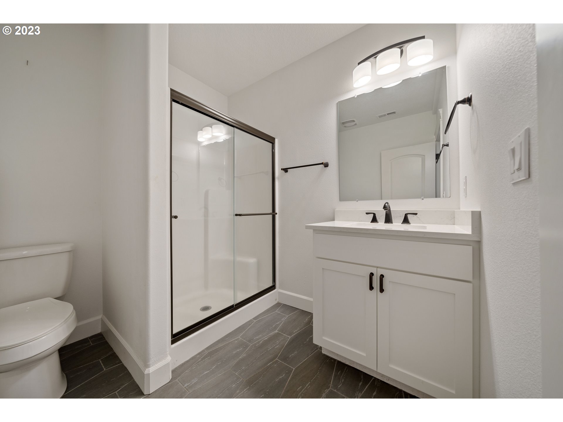 2514 South 19th Court Ridgefield, WA 98642 - Photo 27 of 34 a bathroom with a sink mirror and toilet