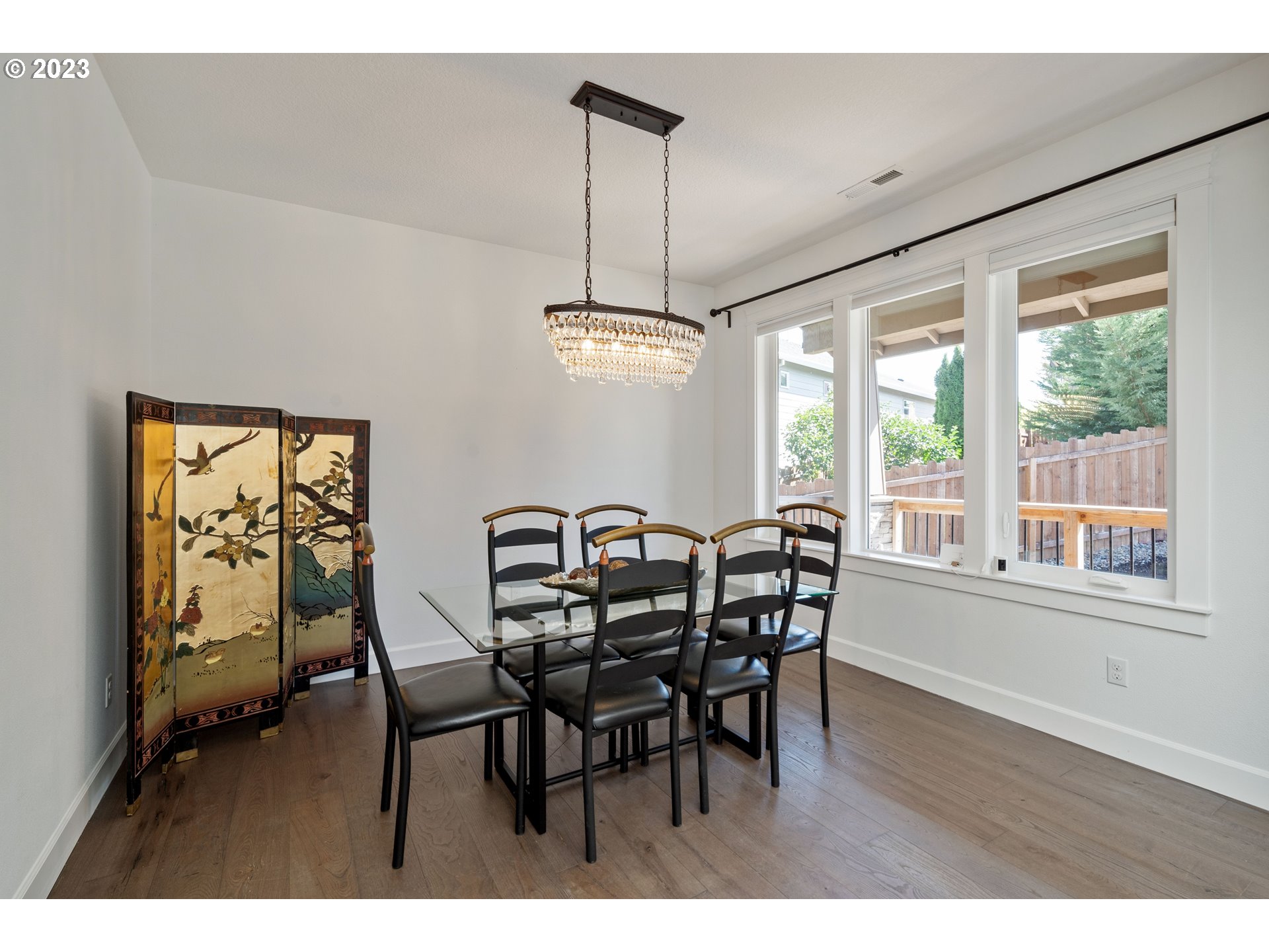 2514 South 19th Court Ridgefield, WA 98642 - Photo 6 of 34 a dining room with furniture a chandelier and wooden floor
