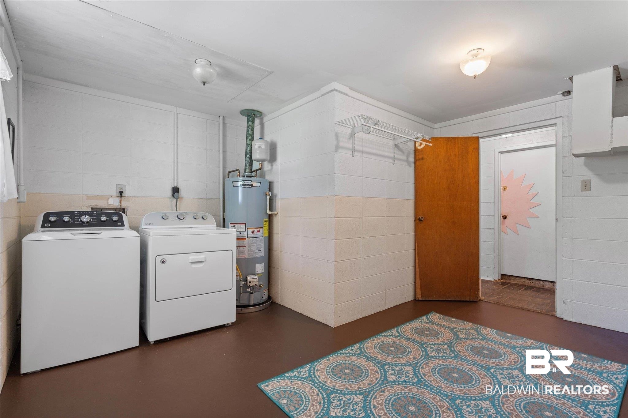 706 Sutherland Drive Chickasaw, AL 36611 - Photo 25 of 33 Laundry room with washing machine and dryer, water heater, laundry area, and concrete block wall
