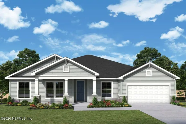 a front view of a house with a garden and yard