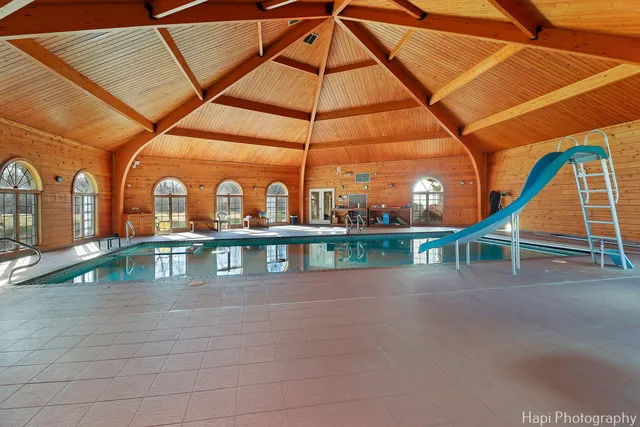 a view of a swimming pool with a lounge chair