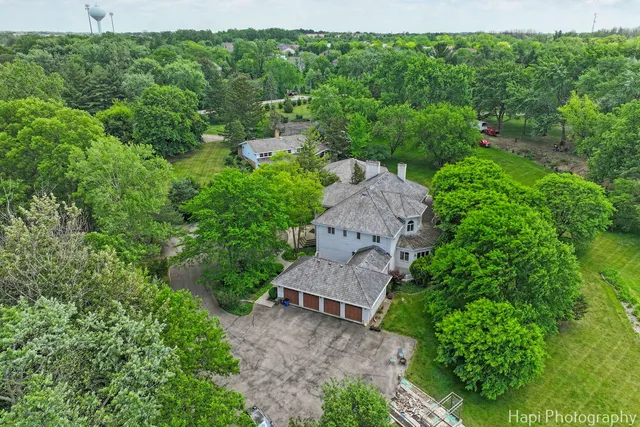 an aerial view of a house with a yard