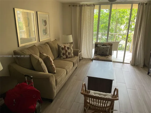 a view of a living room with furniture and a flat screen tv
