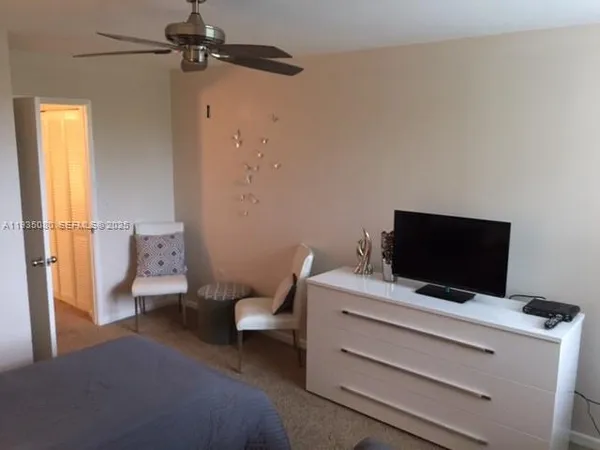 a room with a bed and a flat screen tv