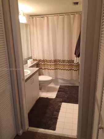 a bedroom with a bed and a television