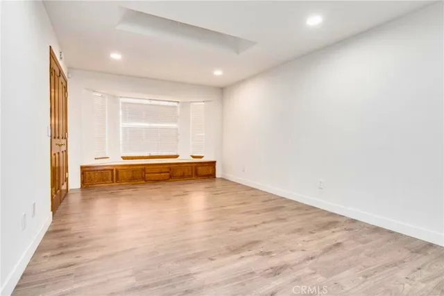 a view of room with window and wooden floor