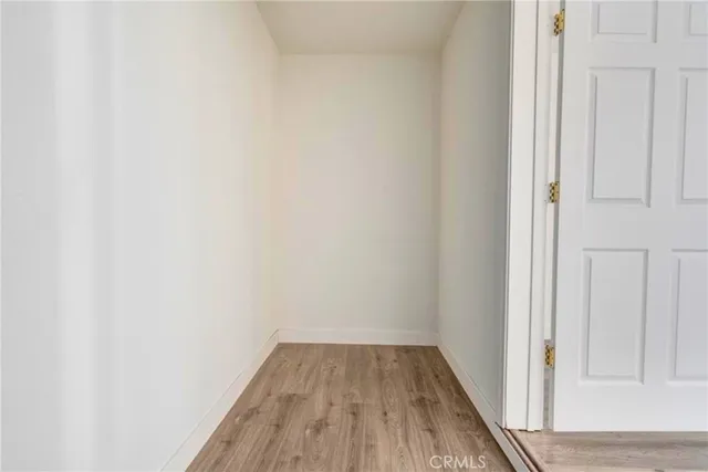 a view of a small space with wooden floor and closet