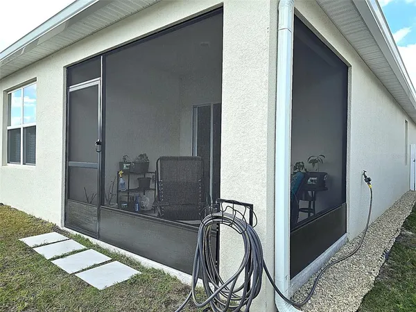 a backyard of a house with table and chairs