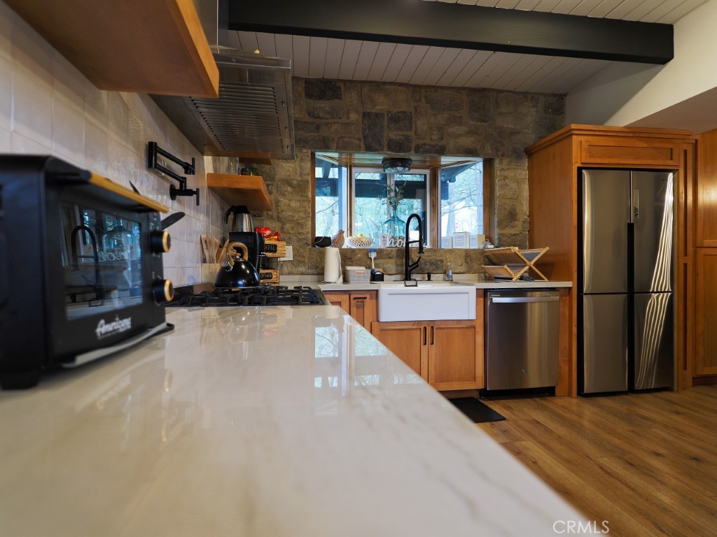 28596 North Bay Road Lake Arrowhead, CA 92352 - Photo 32 of 69 a kitchen with stainless steel appliances granite countertop a refrigerator a sink and a stove