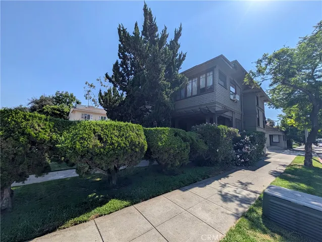 a view of an empty room with a fireplace and a window