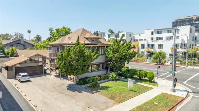 a front view of a house with a garden
